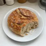 Homemade no knead bread rising in a cast iron pot