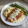 Parmesan Crusted Chicken with Creamy Garlic Sauce served on a plate