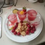 Refreshing Raspberry Margarita cocktail in a glass with lime garnish.