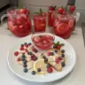 A glass of Refreshing Love Potion Punch garnished with fruit.