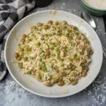 A vibrant plate of Rice and Peas garnished with herbs, showcasing Caribbean cuisine.