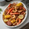 Delicious Spicy Cajun Seafood Boil with shrimp, crab, corn, and potatoes in a spicy broth.