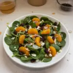 Delicious Spinach Mandarin Salad topped with honey balsamic dressing