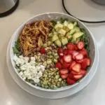 Bowl of Strawberry Crunch Salad with fresh strawberries and crunchy toppings