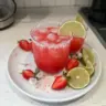Strawberry Lime Mocktail Margarita served in a glass with fresh strawberries and lime