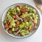 A vibrant bowl of the best avocado salad with fresh ingredients and vibrant colors.