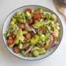 A vibrant bowl of the best avocado salad with fresh ingredients and vibrant colors.
