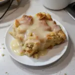 Delicious homemade bread pudding served with a caramel glaze on top