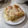Delicious homemade bread pudding served with a caramel glaze on top
