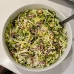 A colorful Scala Chopped Salad with fresh vegetables and dressing