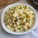 Delicious ultimate potato salad served in a bowl with fresh herbs and spices.