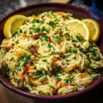 Zesty lemon orzo pasta salad in a bowl with fresh ingredients