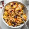 Bowl of quick apple carrot oatmeal topped with fresh apples and carrots