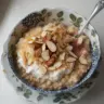 Delicious Almond Croissant Oats with almond slices topped with fresh fruits.