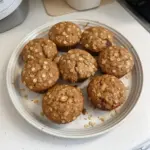 Freshly baked apple cinnamon oat muffins on a wooden table