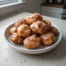 Delicious Apple Fritter Bites on a plate, ready to enjoy as a sweet snack.