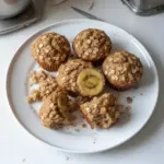 Freshly baked banana oatmeal muffins on a wooden table
