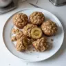 Freshly baked banana oatmeal muffins on a wooden table
