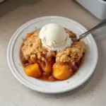 Delicious crock pot peach cobbler ready to serve