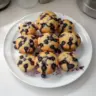Freshly baked blueberry muffins on a cooling rack