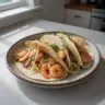 Bobby Flay's flavorful shrimp tacos garnished with fresh ingredients