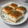 Delicious baked cod served with herbs and lemon in a baking dish