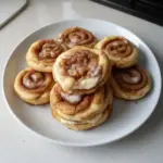 Delicious Cinnamon Roll Cheesecake Cookies with frosting and cinnamon swirl