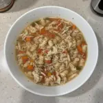Bowl of Crock Pot Italian Chicken Soup with fresh herbs and vegetables