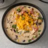 Crockpot Creamy Chicken Taco Soup served in a bowl with toppings.