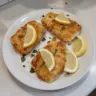 Delicious air fryer cod fish served with lemon and herbs