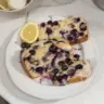 Sliced easy lemon blueberry bread on a wooden serving board