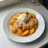 Delicious easy peach cobbler with fresh peaches and a golden crust