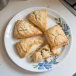 Freshly baked plain scones on a cooling rack