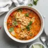 Bowl of easy Thai noodle soup garnished with fresh herbs and lime