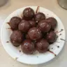 Glazed chocolate munchkins donut holes, a delicious treat for chocolate lovers.