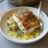Golden seared cod fillet served with herb butter sauce on a plate