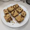Healthy oatmeal peanut butter chocolate chip breakfast bars on a wooden plate