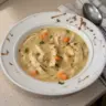Bowl of Healthy Chicken Pot Pie Soup with vegetables and herbs