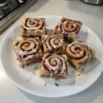 Irresistible cinnamon roll bliss bars ready to be enjoyed, showcasing gooey cinnamon and frosting.
