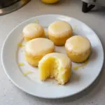 Mini lemon drop cakes topped with lemon glaze and zest.