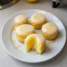 Mini lemon drop cakes topped with lemon glaze and zest.