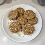 Oatmeal protein breakfast cookies on a plate with a glass of milk