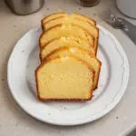 Delicious homemade Pound Cake served on a plate with fresh berries.