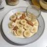 Delicious Protein Banana Pudding topped with banana slices and crushed nuts