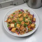 Delicious Tofu Spring Roll Salad with fresh vegetables and dipping sauce