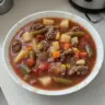 Bowl of hearty Vegetable Beef Soup with colorful vegetables and tender beef chunks.