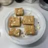 Delicious white chocolate blondies topped with a drizzle of white chocolate