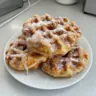 Delicious apple fritter waffles topped with glaze and apple chunks