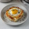 Delicious Baked Eggs Napoleon served with garnishes