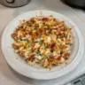 BBQ Ranch Chicken Casserole topped with cheese and fresh herbs